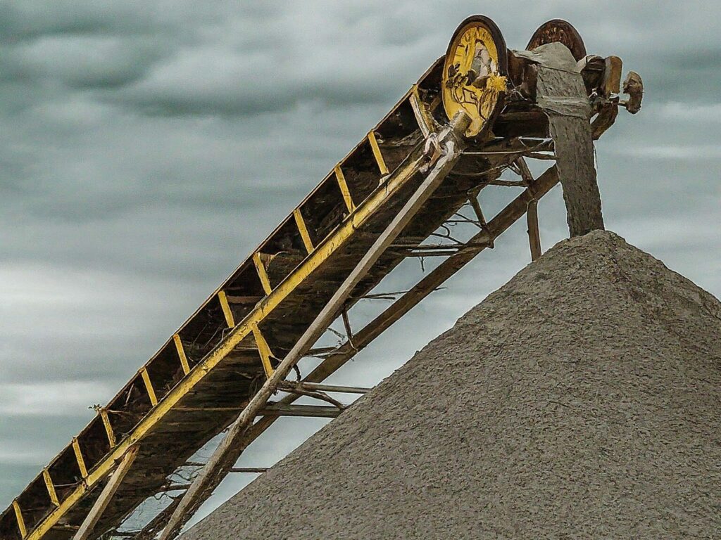 A modern weighbelt feeder in action at a cement plant, demonstrating its role in controlling the flow of raw materials for precise cement production.